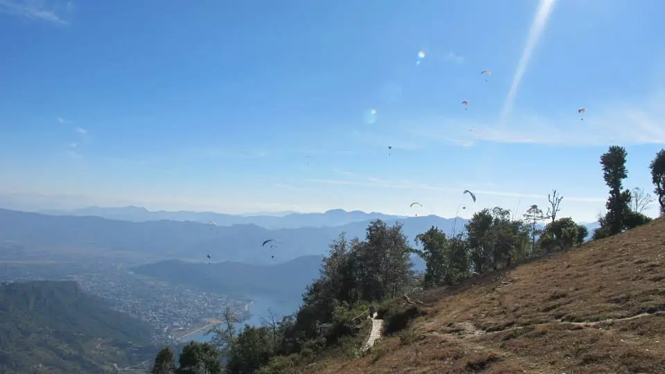 Adventure paragliding in Pokhara with Himalayan peaks and scenic valley landscape