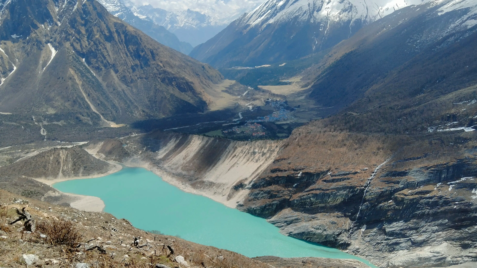 Birendra Tal on the Manaslu Circuit Trek, featuring a turquoise glacial lake, snow-capped Himalayan peaks, and a peaceful alpine landscape in Nepal.