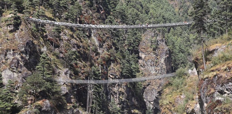 Cross suspension bridges and enter Sagarmatha National Park before reaching Namche Bazaar. (1)