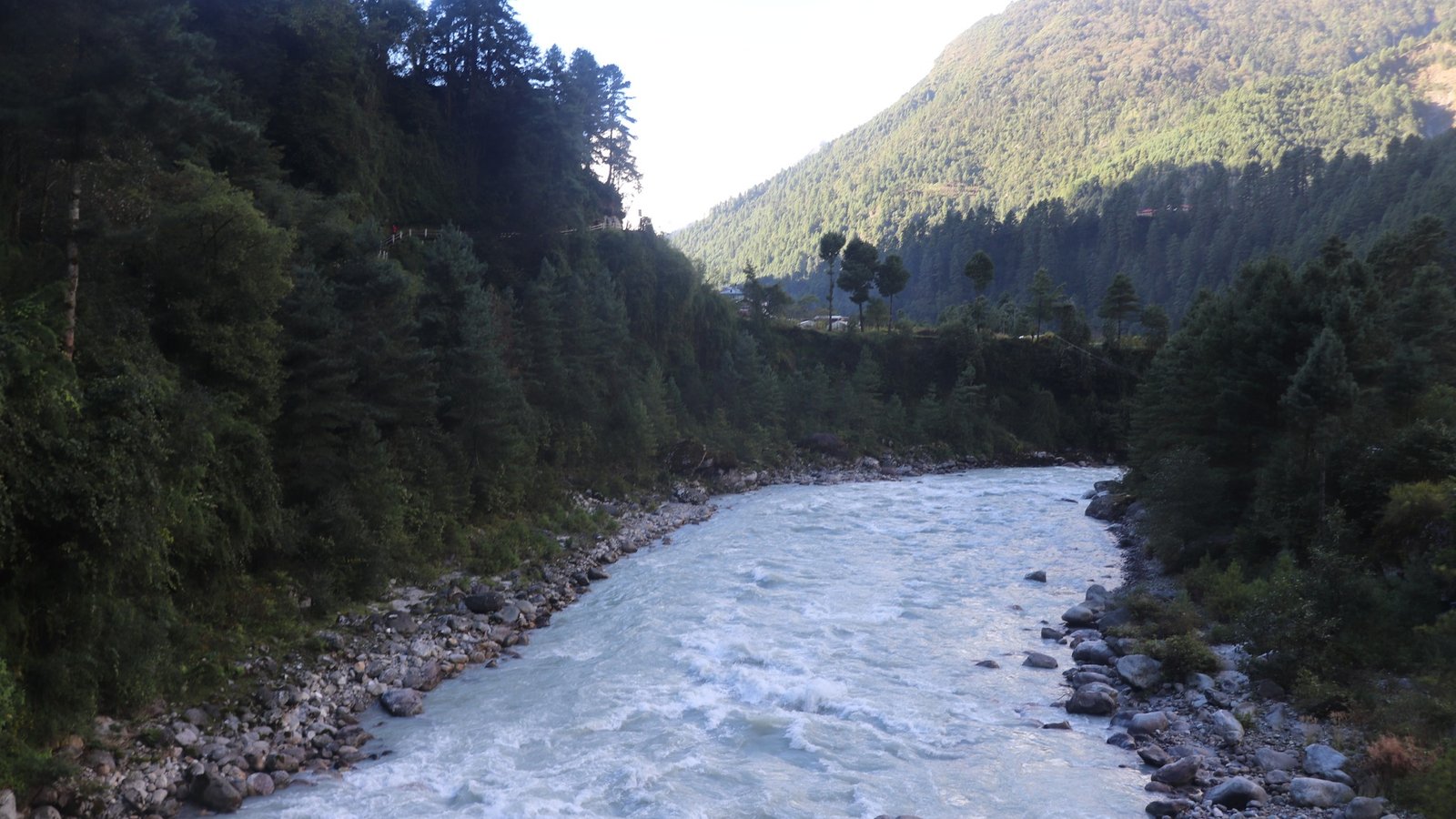 Dudh Koshi River flowing through lush green valleys in the Everest region, Nepal, along the trekking route to Everest Base Camp.