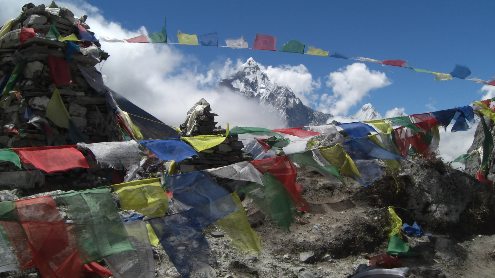 Everest Base Camp trek route at Thukla Pass featuring trekkers, rocky trails, and panoramic Himalayan views