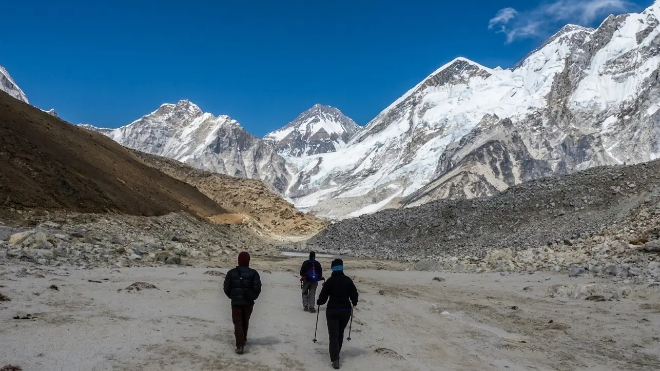 Everest High Passes Trek: Trekkers walking beneath dramatic Himalayan peaks near Everest Base Camp