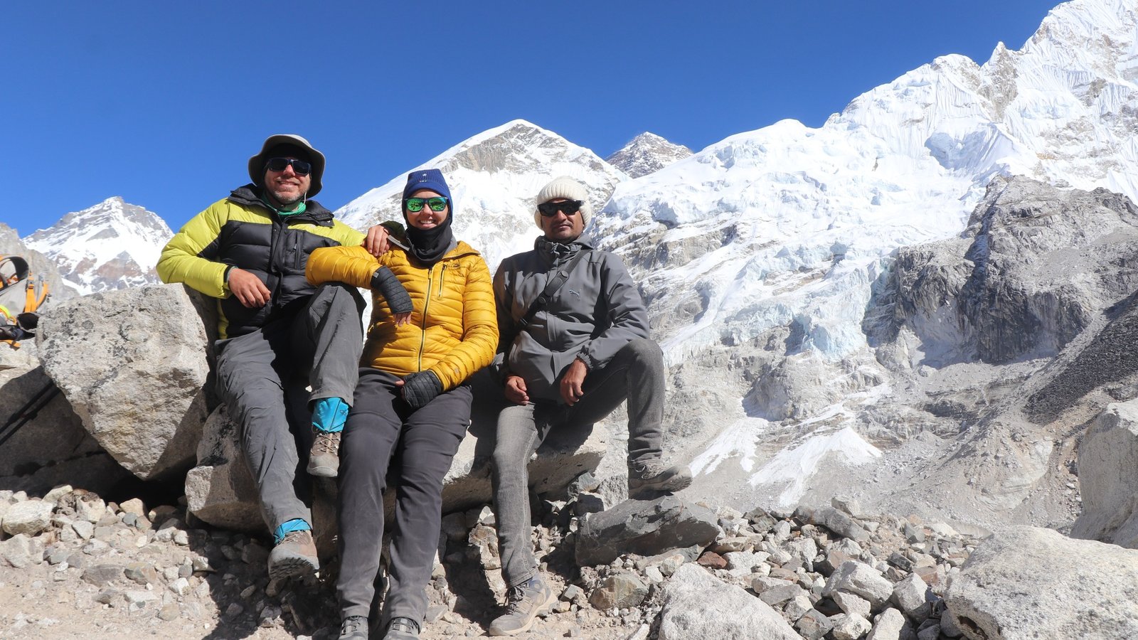 Trekkers crossing high-altitude snowy pass with panoramic Himalayan peaks during Everest Three Passes Trek