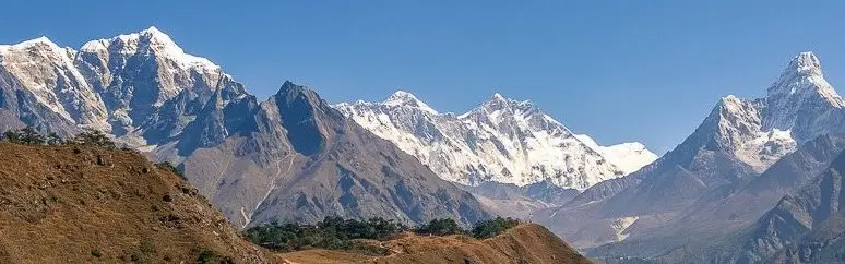 Trekker hiking towards Everest Base Camp with snow-capped mountains in background