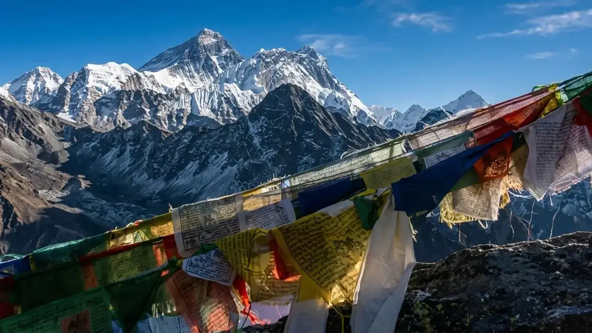 A spectacular morning view from the summit of Gokyo Ri, featuring a panoramic sweep of the Himalayas. The peaks visible include Mount Cho Oyu (8,201m), Mount Everest (8,848.86m) and Mount Makalu(8,485m).