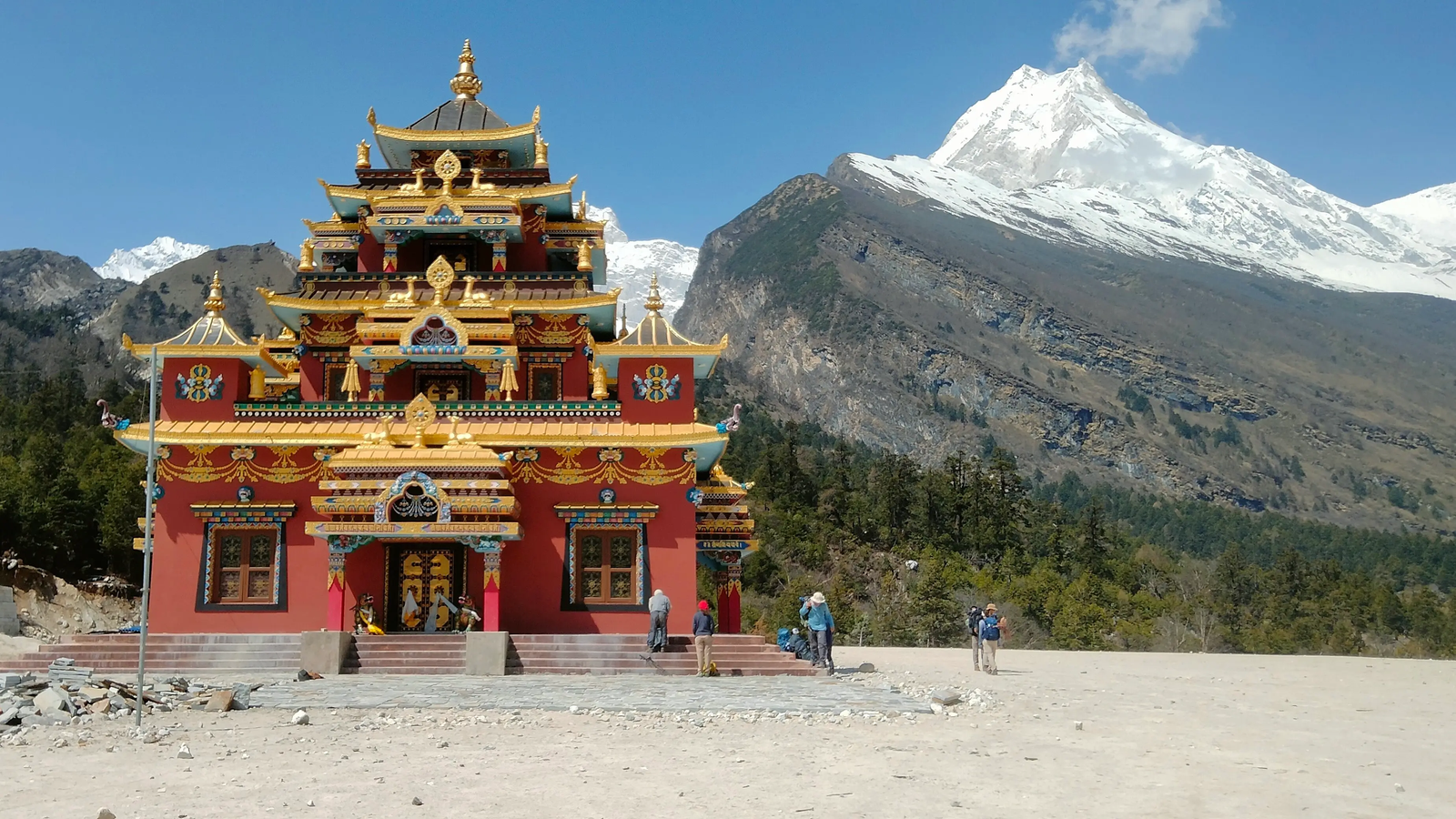Manaslu Circuit Trek panoramic mountain views from Syala village with snow-capped Himalayan peaks and an alpine valley in Nepal.