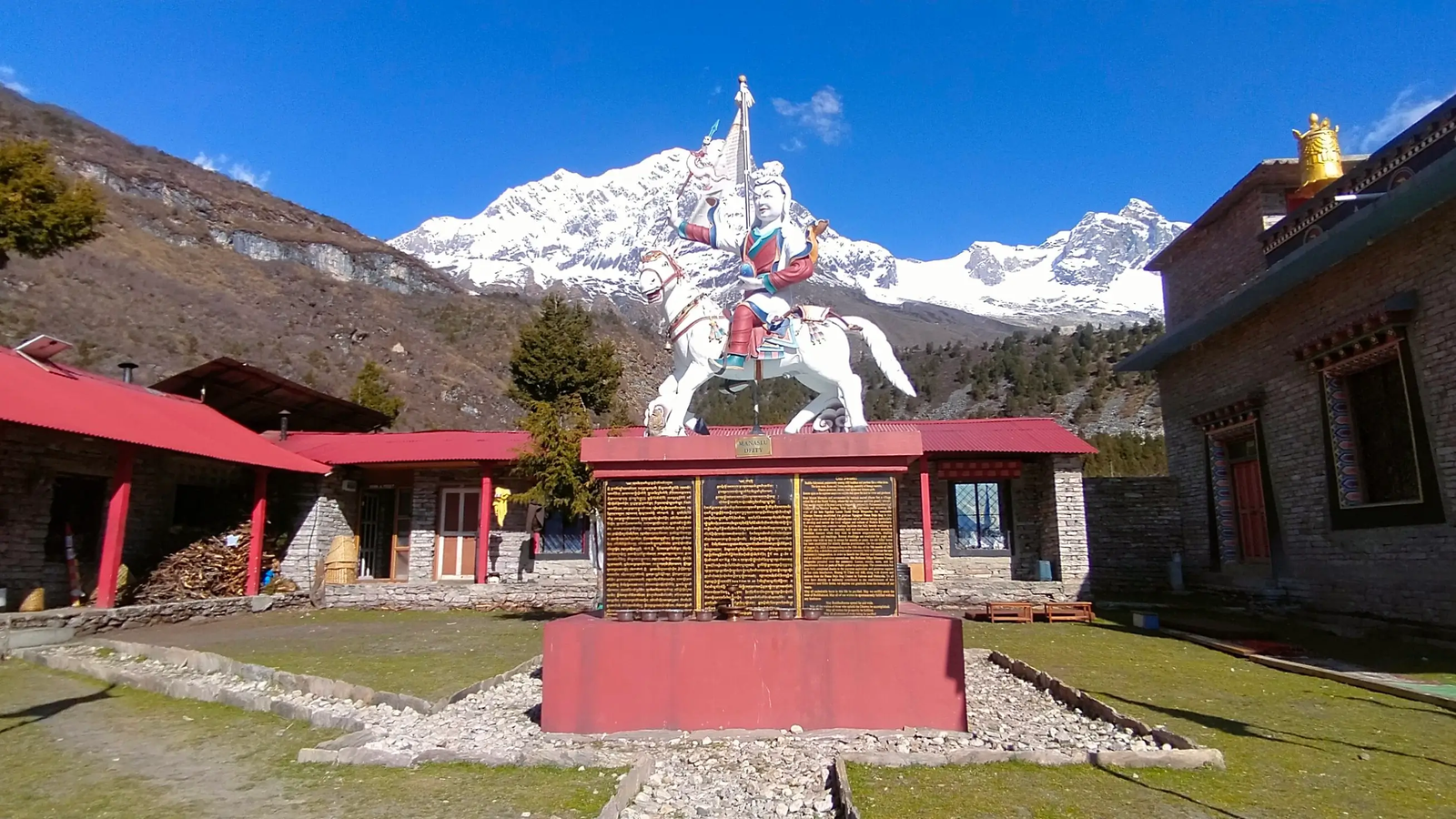 Samagaon village monastery on the Manaslu Circuit Trek with Himalayan backdrop, prayer flags, and peaceful high-altitude Tibetan Buddhist culture in Nepal.