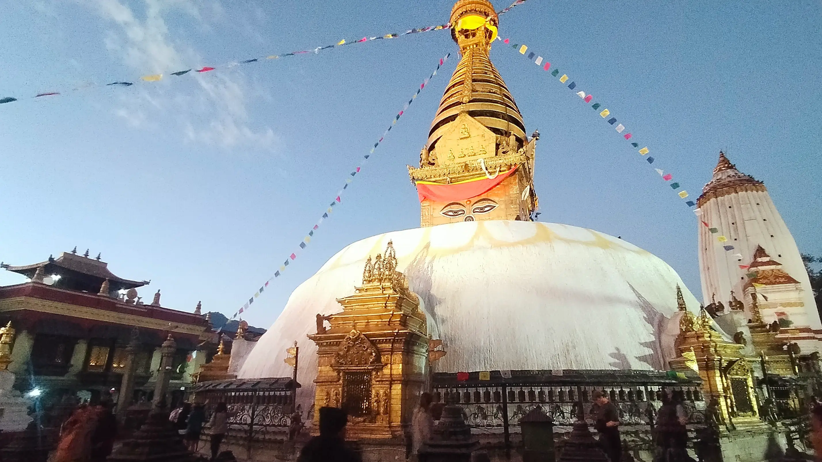 Swayambhu Stupa golden spire and prayer wheels close shot