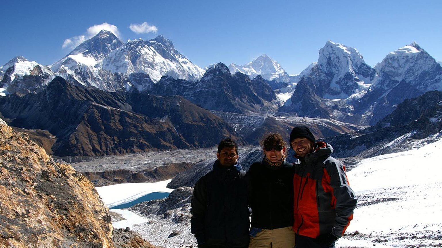 Trekkers at Renjo La Pass top, panoramic views of Everest, Lhotse, Gokyo Lakes, and high Himalayan adventure in Nepal